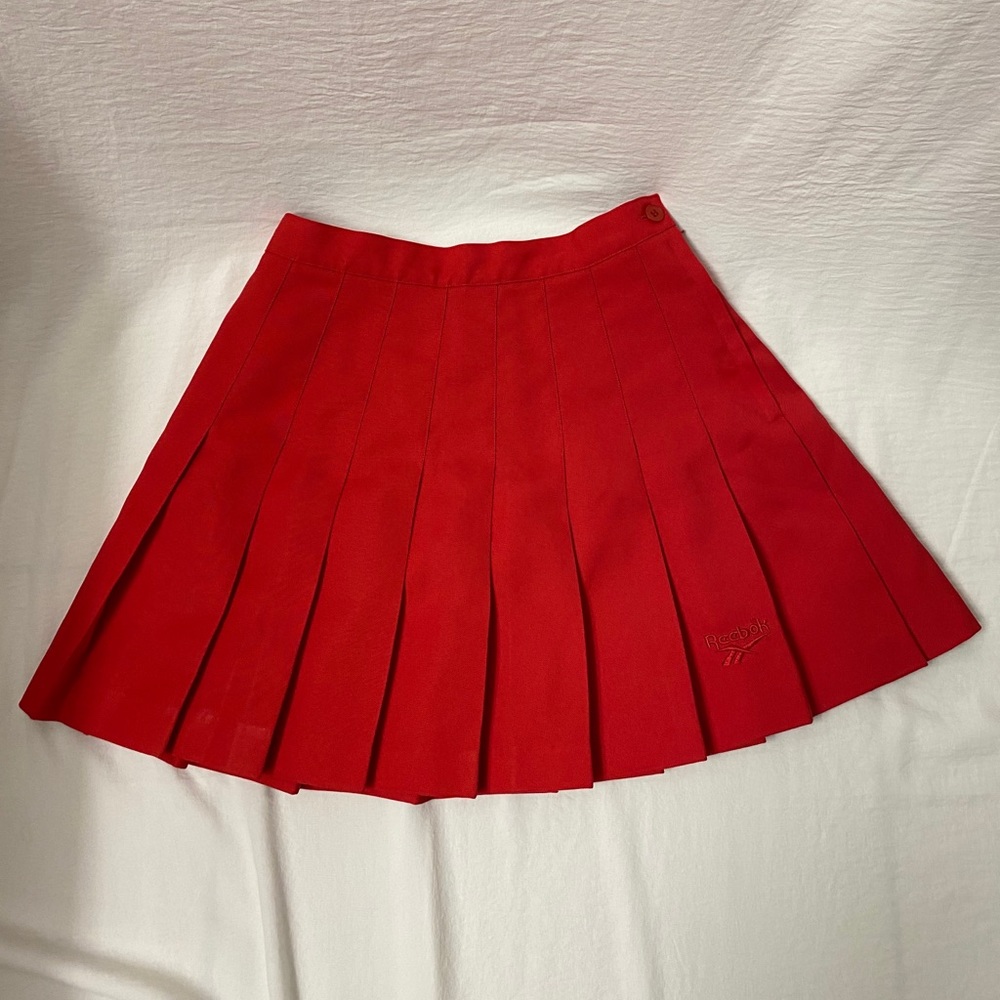 red pleated Reebok tennis skirt